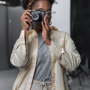 front-view-woman-holding-photo-camera